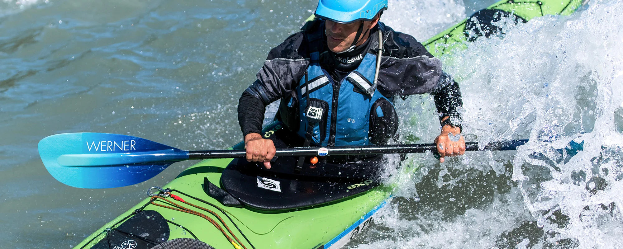 Whitewater kayaker using a Werner paddle