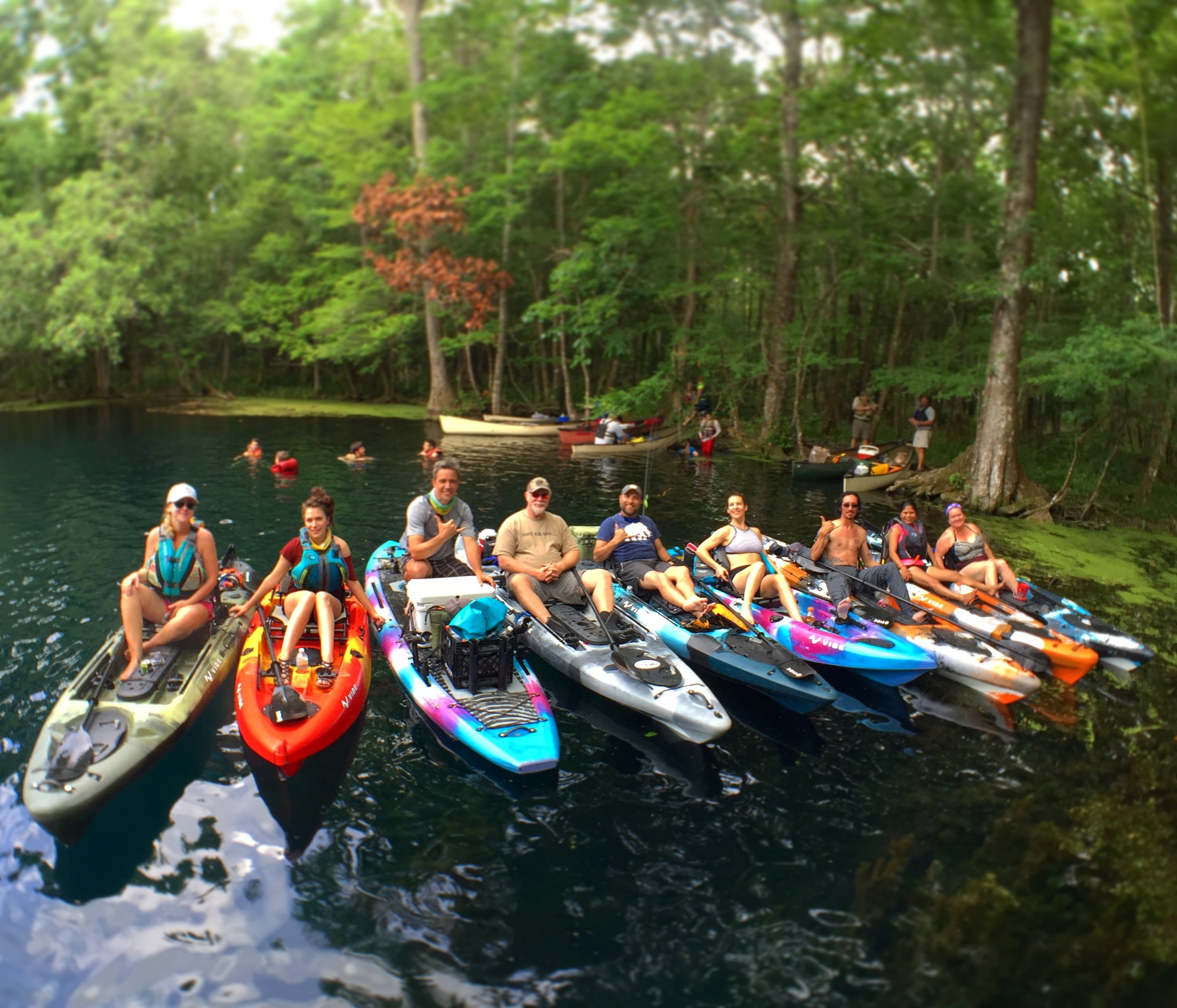 A group of people on kayaks enjoying the lake 