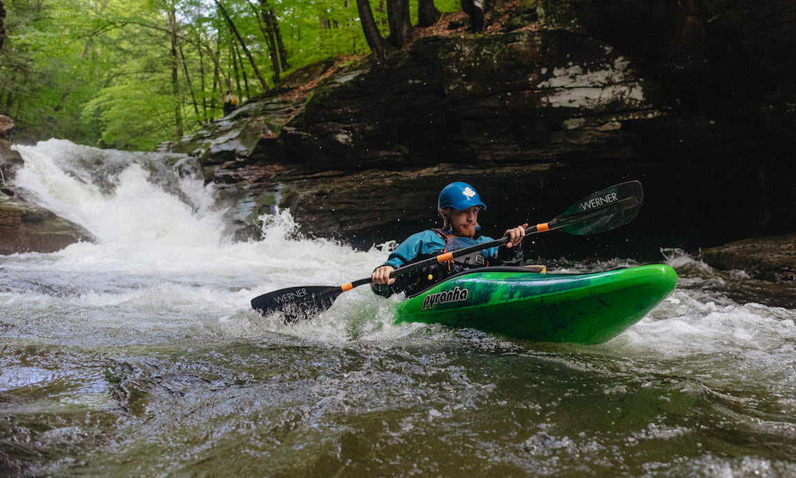 Man white water kayaking in Pyranha kayak 