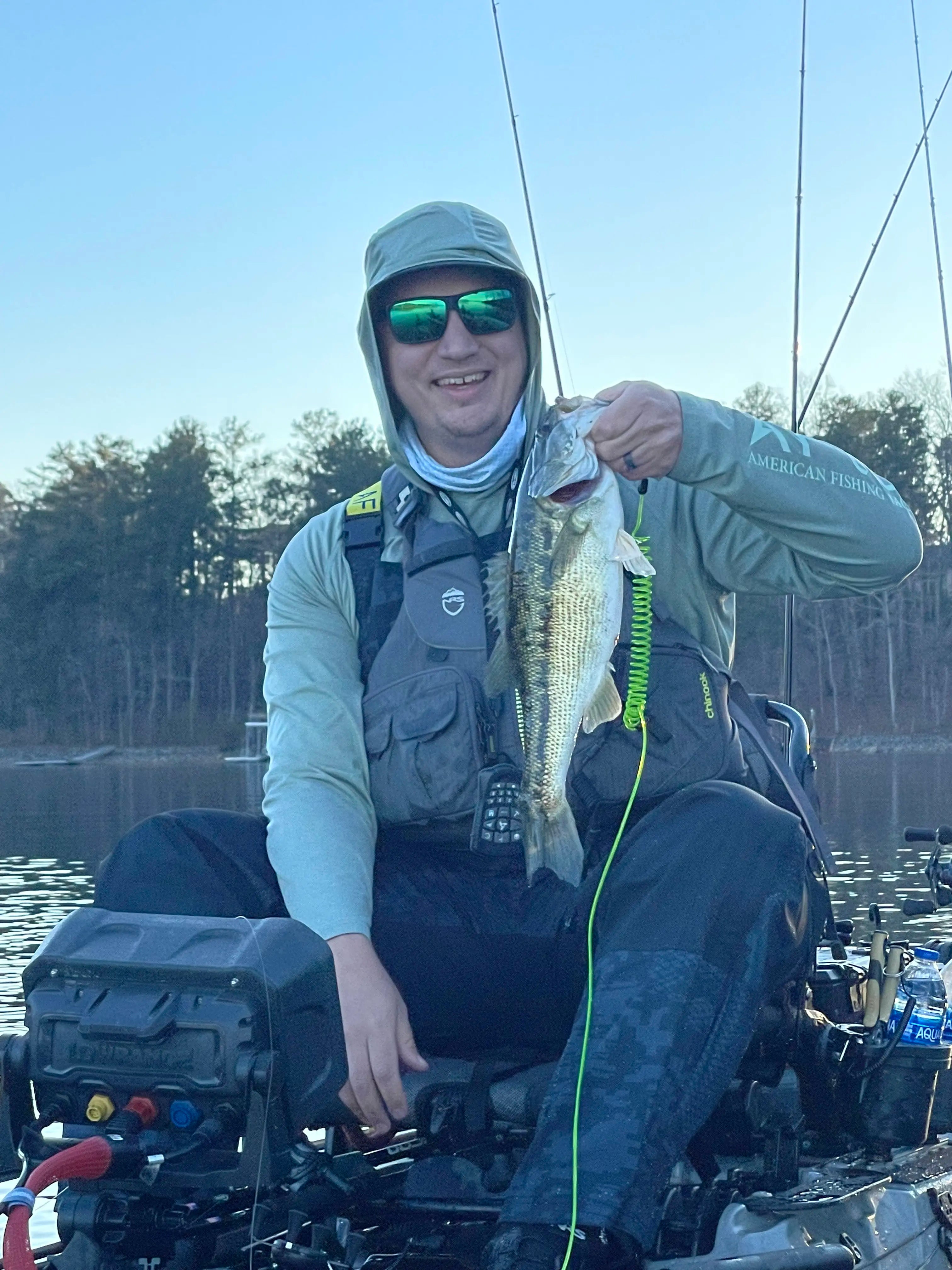 Nathan Skinner holding a spotted bass while fishing in a kayak