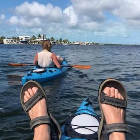 Tim and Ginger paddling kayaks in the ocean