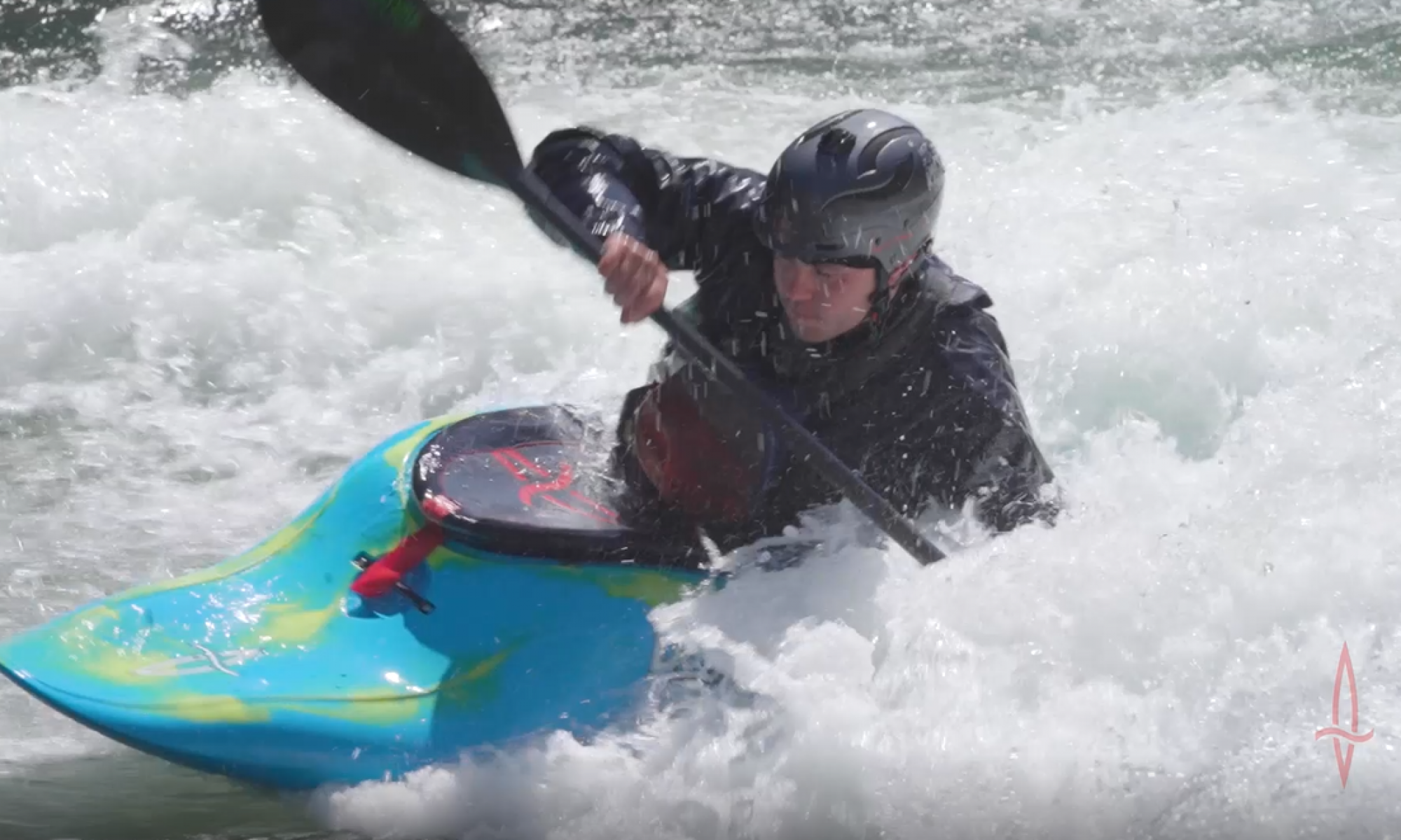 Whitewater kayaker surging down rapid